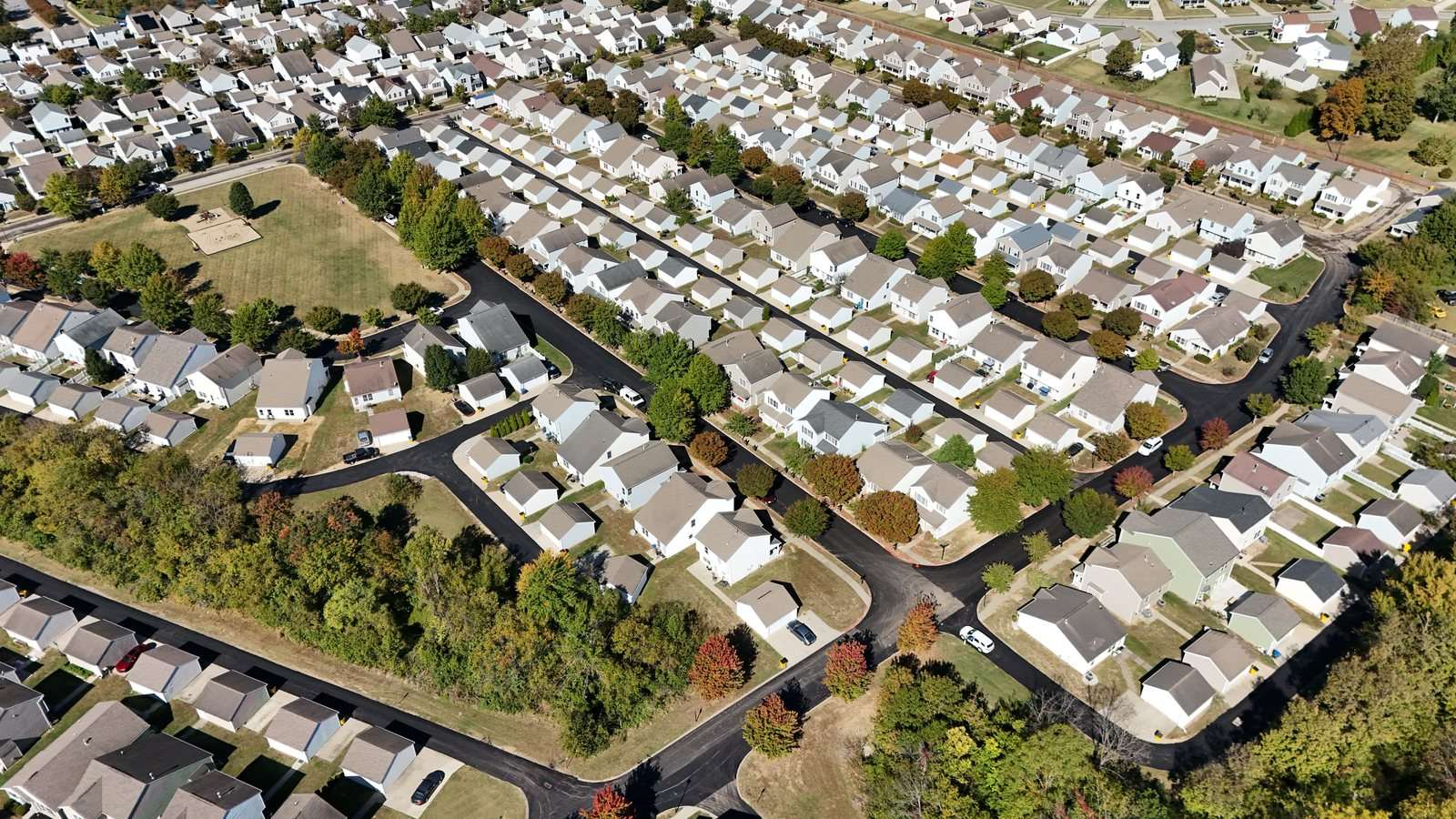 Drone view of a subdivision with freshly paved black streets